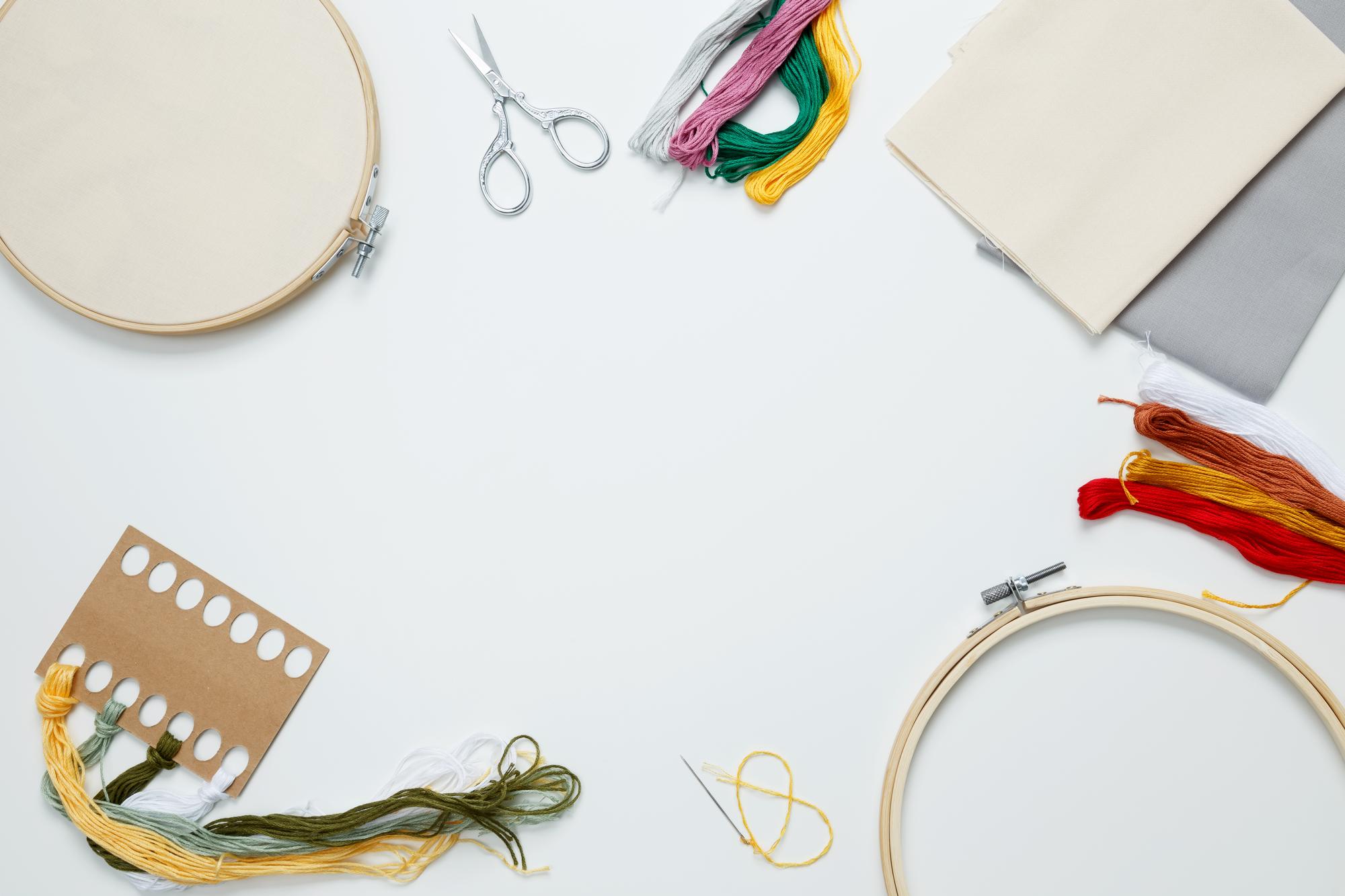 Workshop table with hoops, threads and design notes