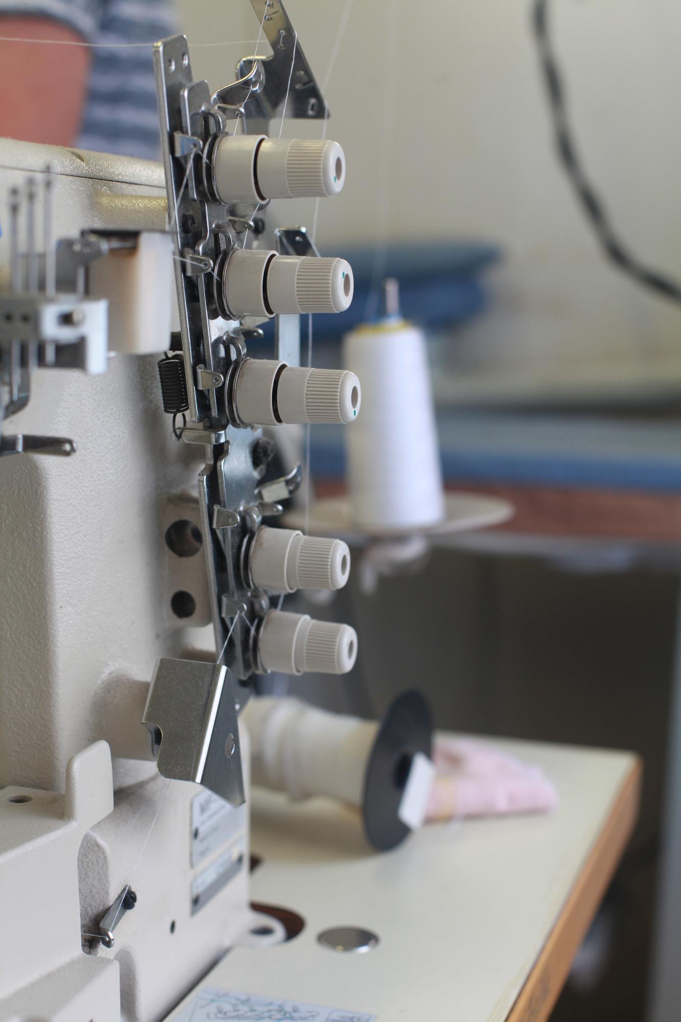 Interior of embroidery studio with machines and threads