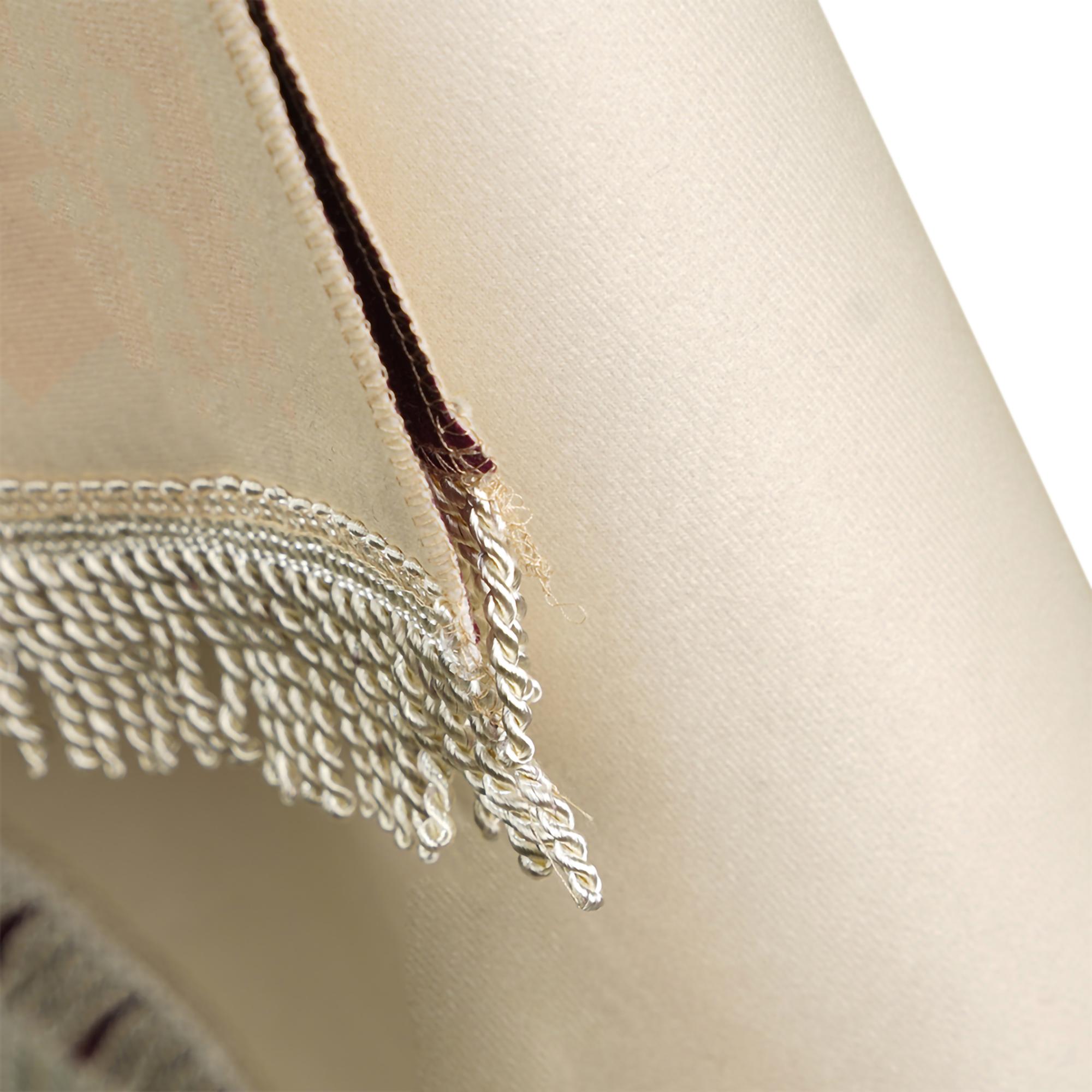 Close crop of satin stitches on linen